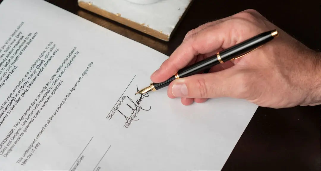 Handwriting of a man signing paper with a fountain pen