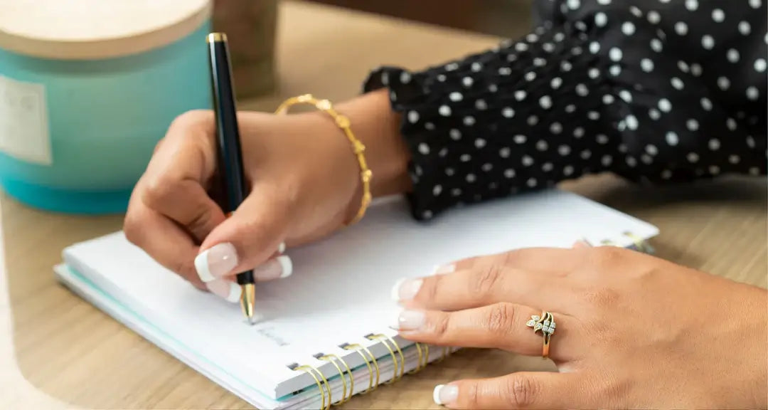 woman writing in notepad
