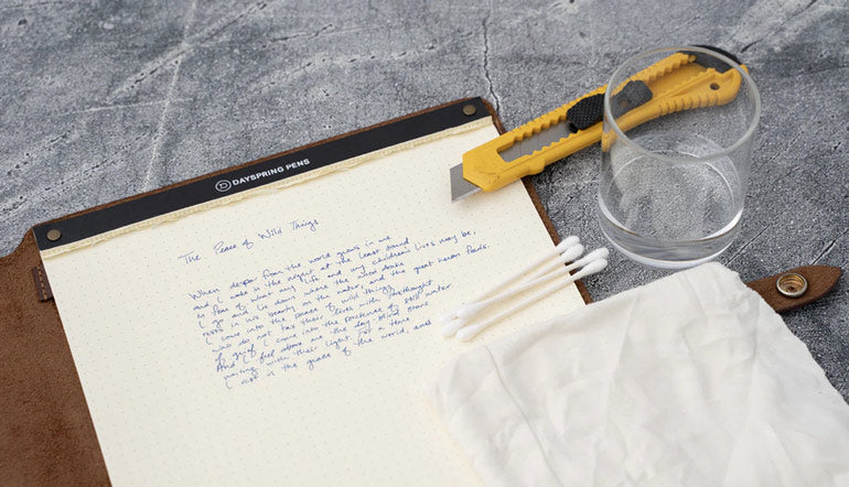 paper with yellow cutter on the top of the table