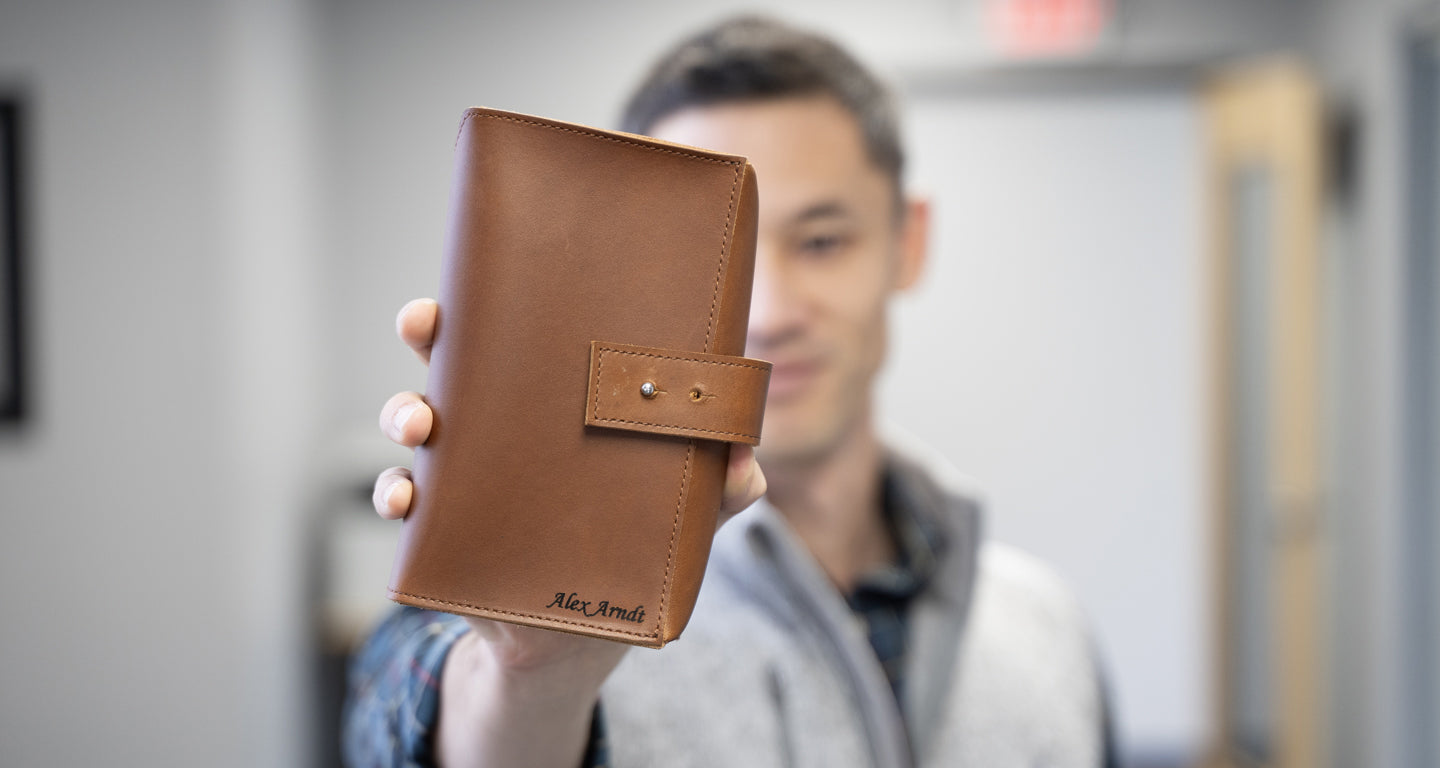Man holding a custom engraved leather Tech Organizer