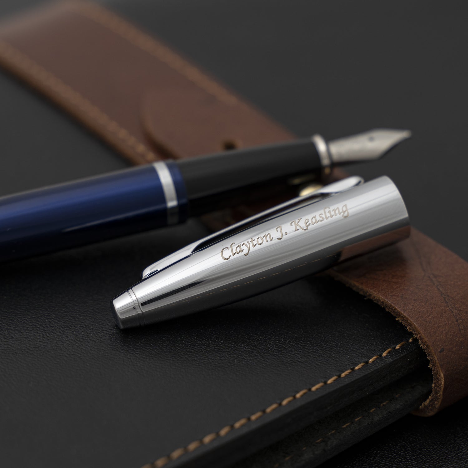 Engraved Calais Blue Fountain Pen with cap removed on journal