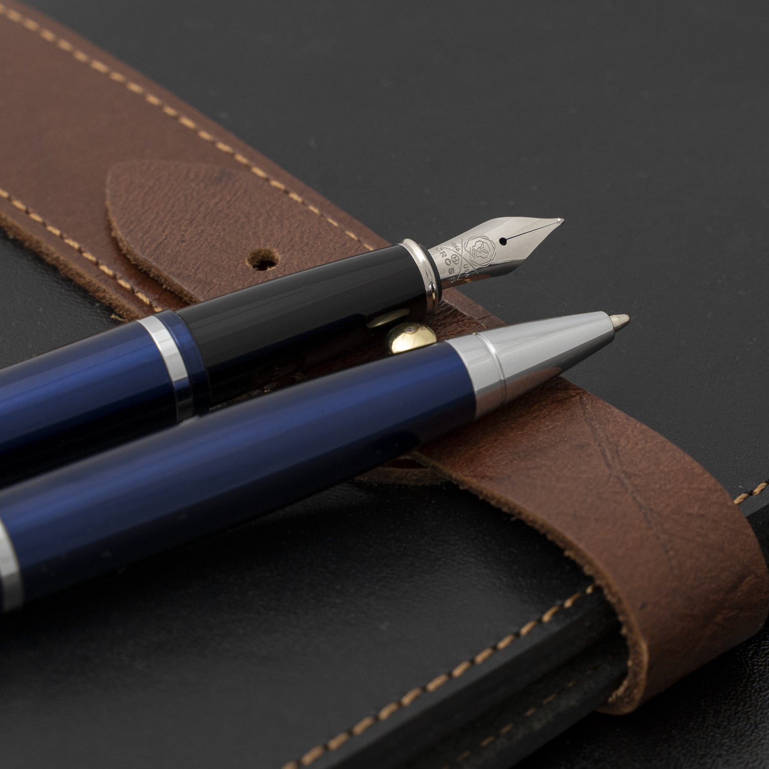Calais Blue Ballpoint and Fountain Pen Set placed on a journal