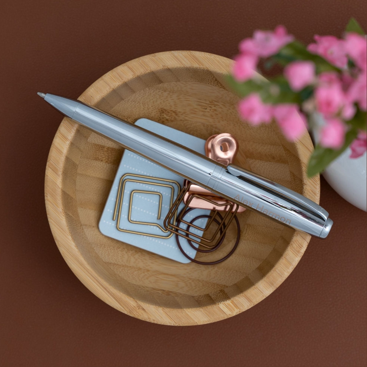 Engraved Abingdon Chrome Ballpoint sitting on display on a wooden bowl