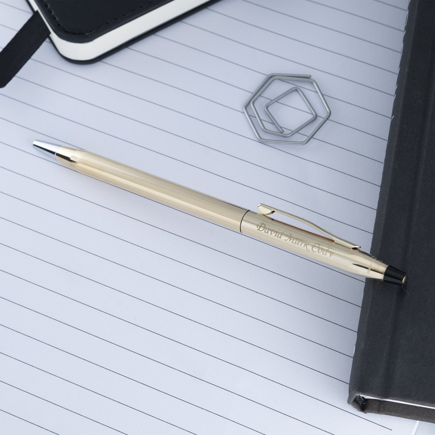 Engraved Classic Century 10k Ballpoint sitting on a notebook and journal