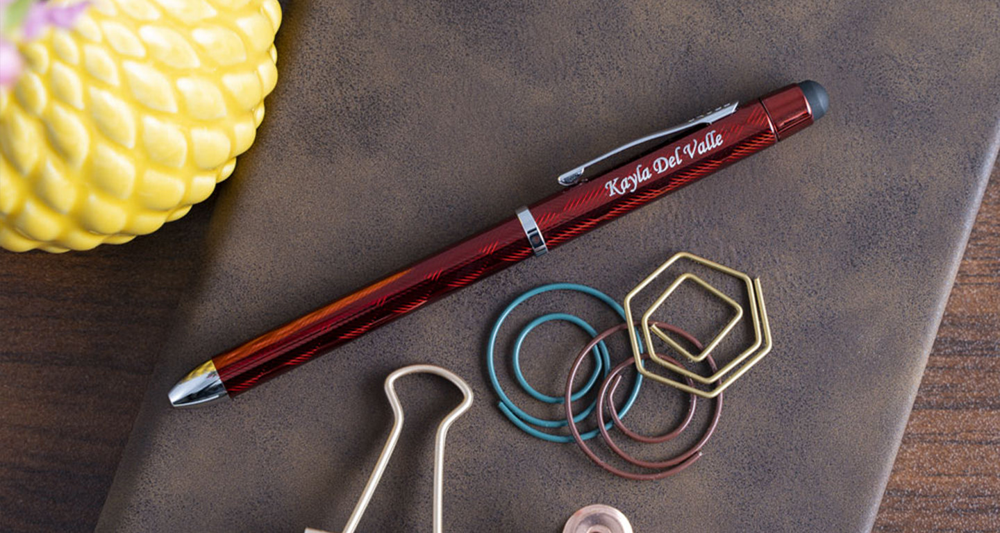 A red cross tech 3 lying on a brown journal with paperclips right beside it.