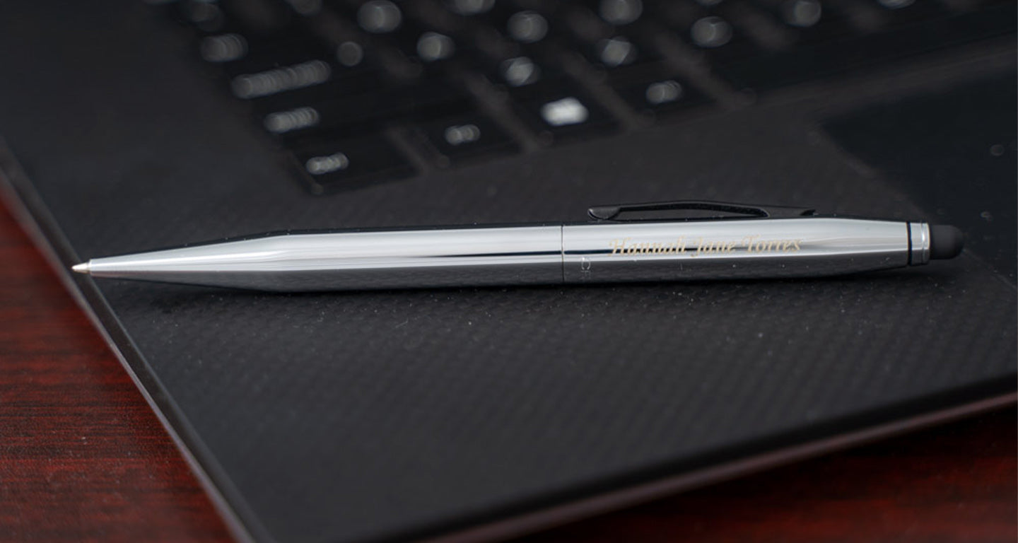 a chrome cross tech2 lying on a laptop