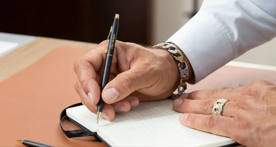 Man writing notes with a black pen