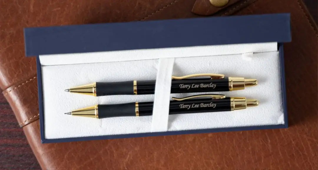 Black Monroe Pen and Pencil Set in display case on journal