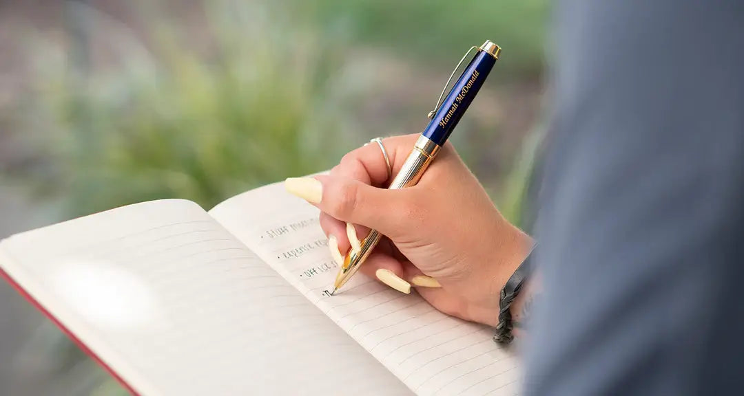 Person writing using personalized pen