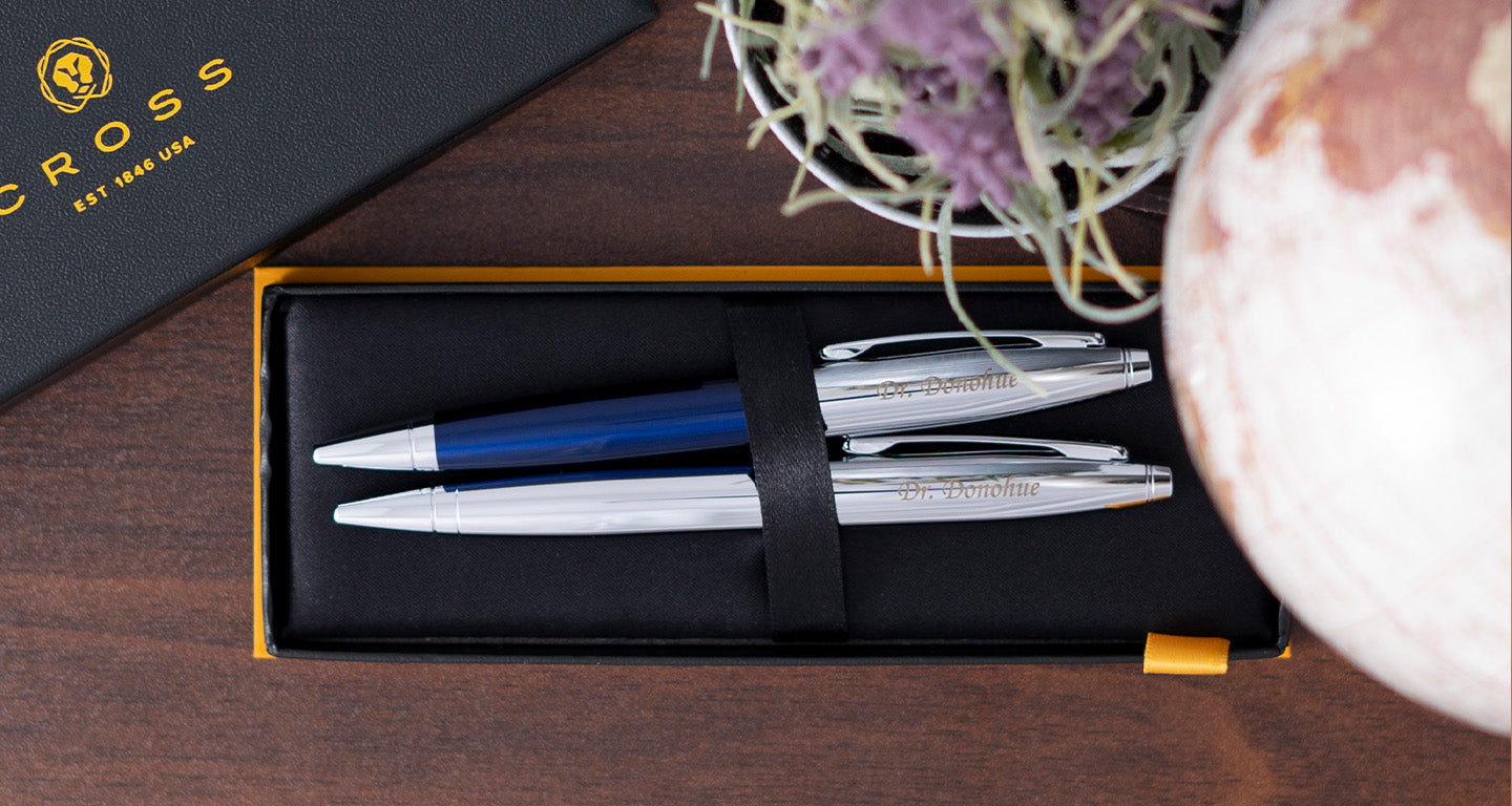 Cross Calais Blue and Chrome Set in box sitting on desk beside other desk items.