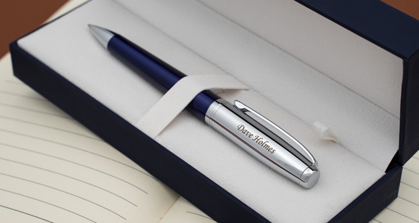 Blue Abingdon ballpoint resting in gift box on top of notepad