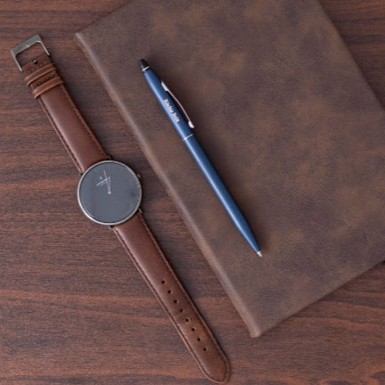 Engraved Click Midnight Blue Ballpoint placed on journal next to wrist watch
