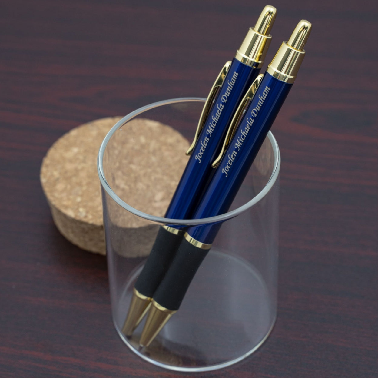 Engraved Monroe Blue Pen and Pencil Set placed on display in a glass container