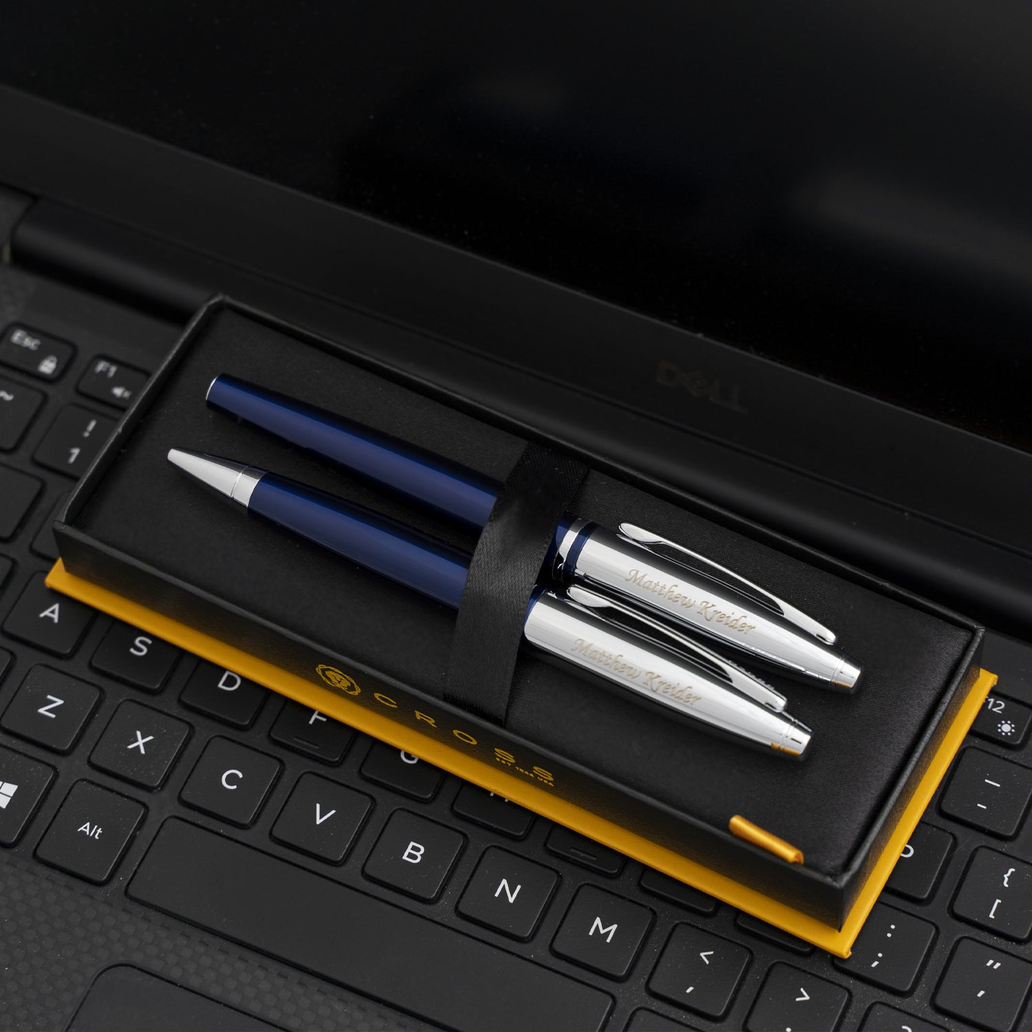Engraved Calais Blue Rollerball and Ballpoint Set boxed and placed on keyboard