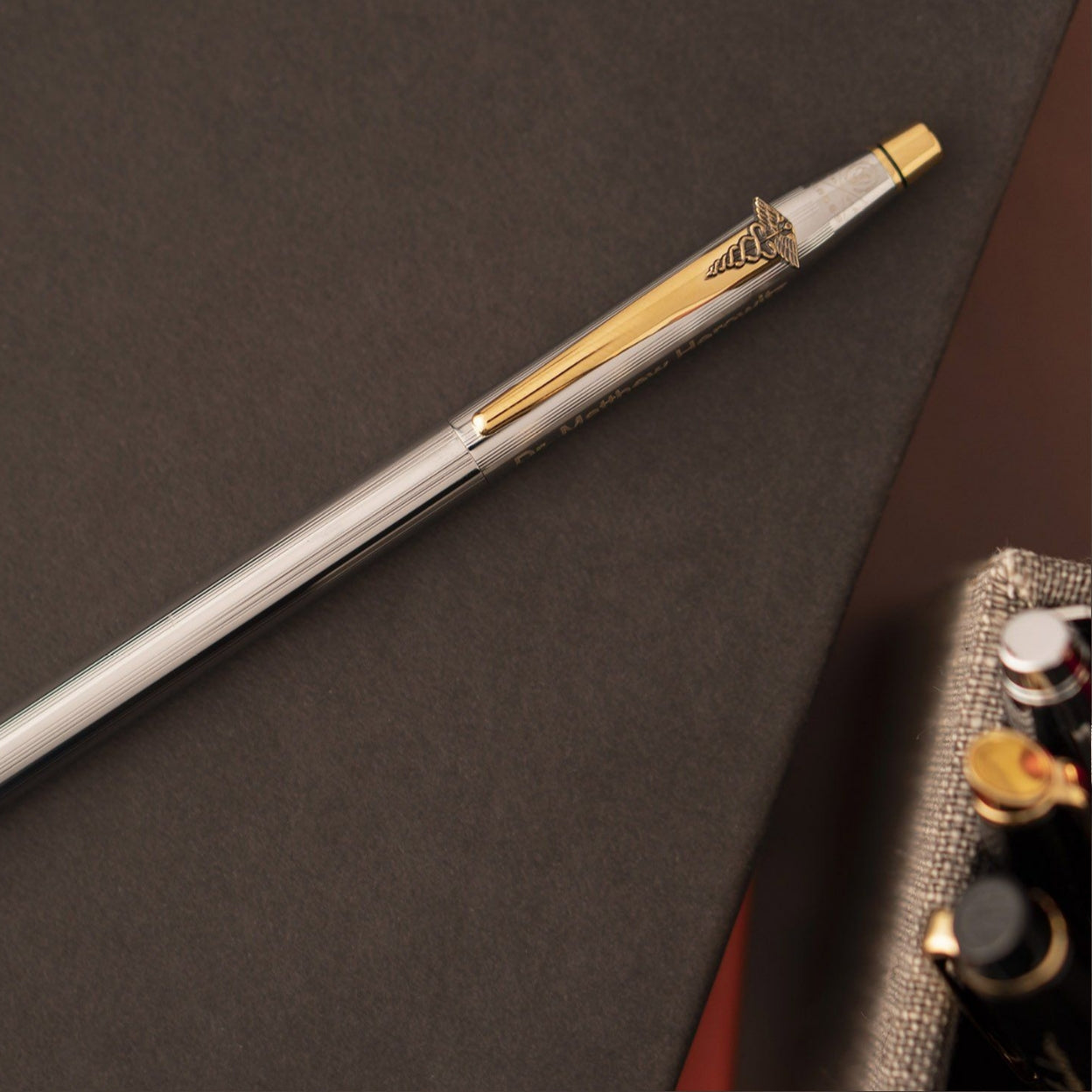 Classic Century Medalist Ballpoint Medical Emblem sitting on a book showing the medical emblem