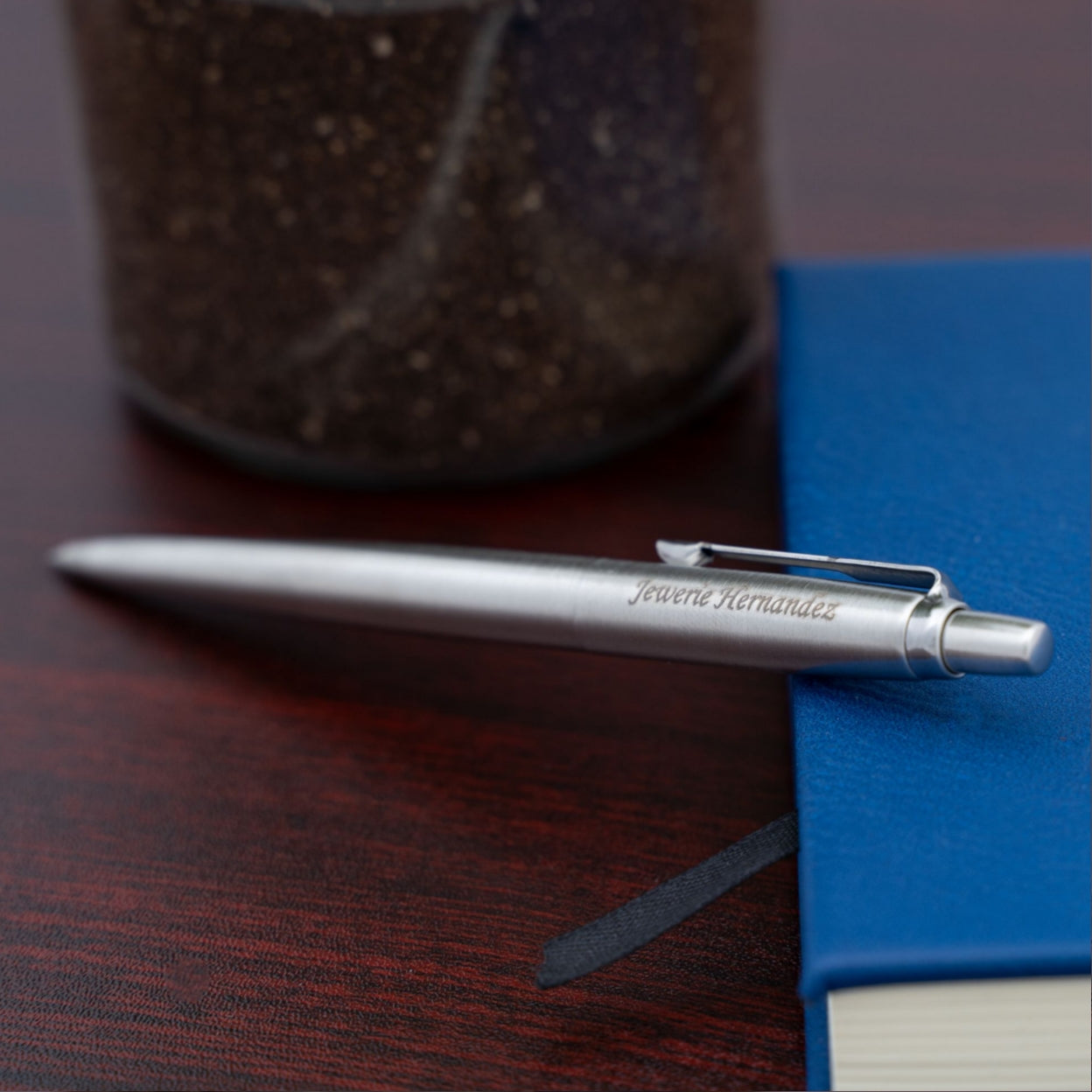 Engraved Jotter Chrome Trim Ballpoint placed next to a journal