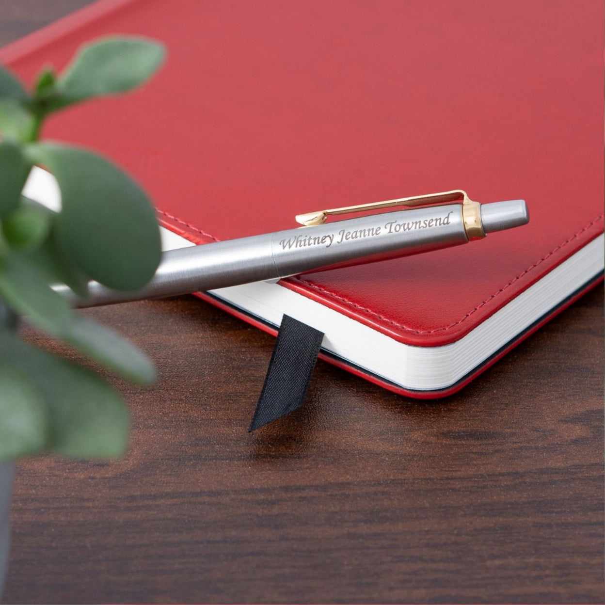 Engraved Jotter Gold Trim Ballpoint placed next to a journal