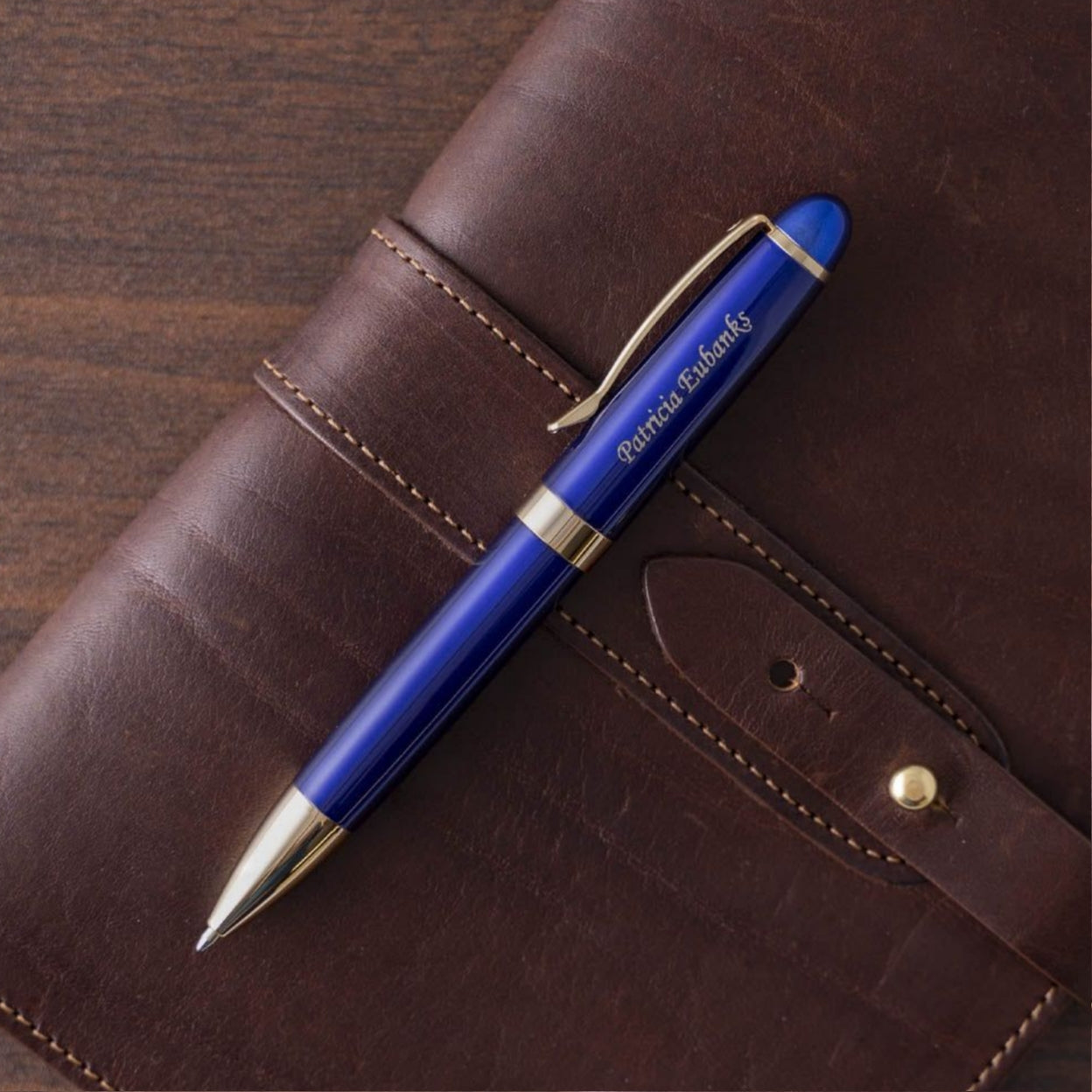 Engraved Alexandria Blue Ballpoint placed on top of journal