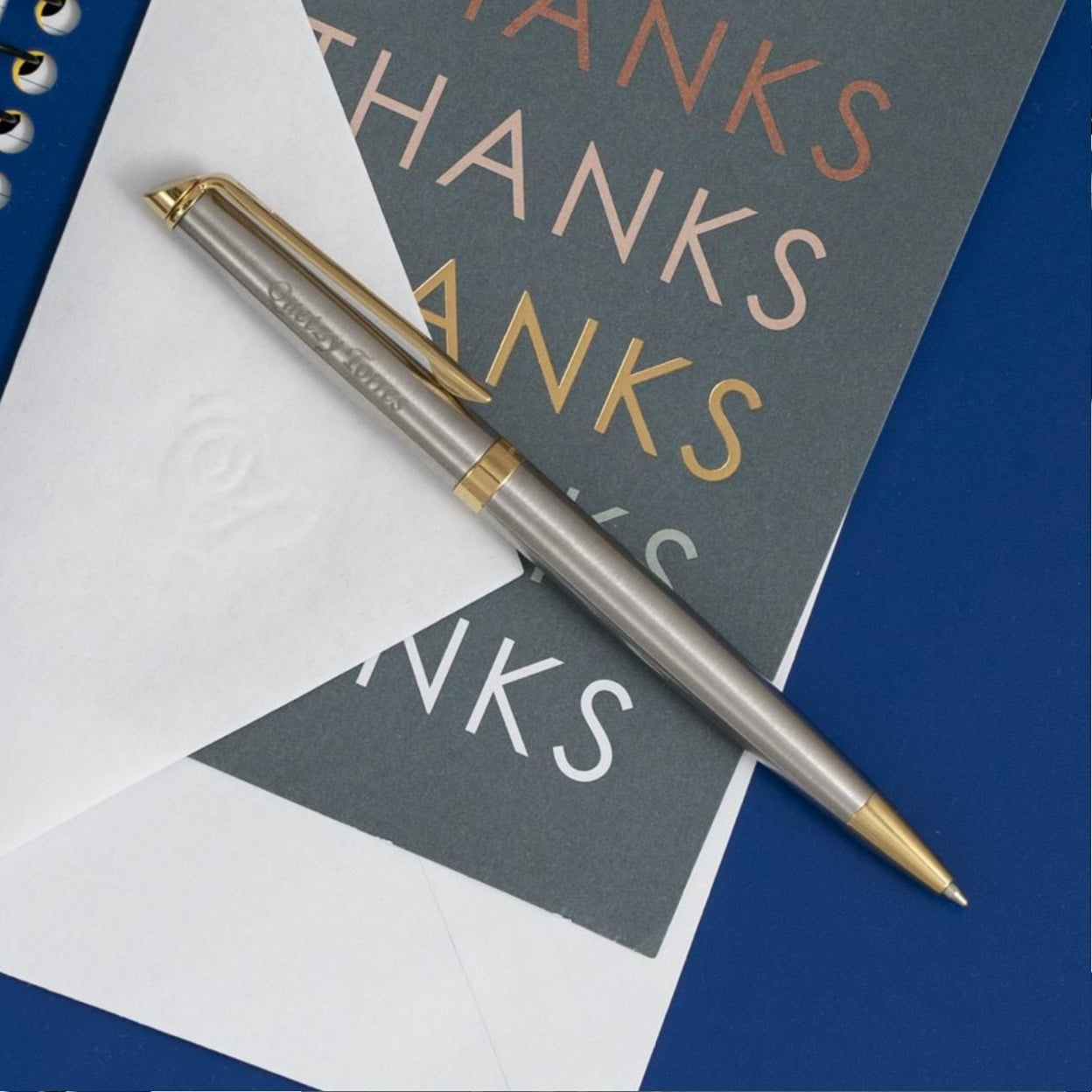 Engraved Hemisphere Stainless Gold Trim Ballpoint on top of gift card