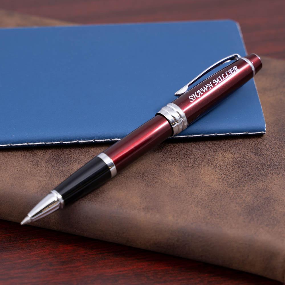 Engraved Bailey Red Rollerball placed on a journal