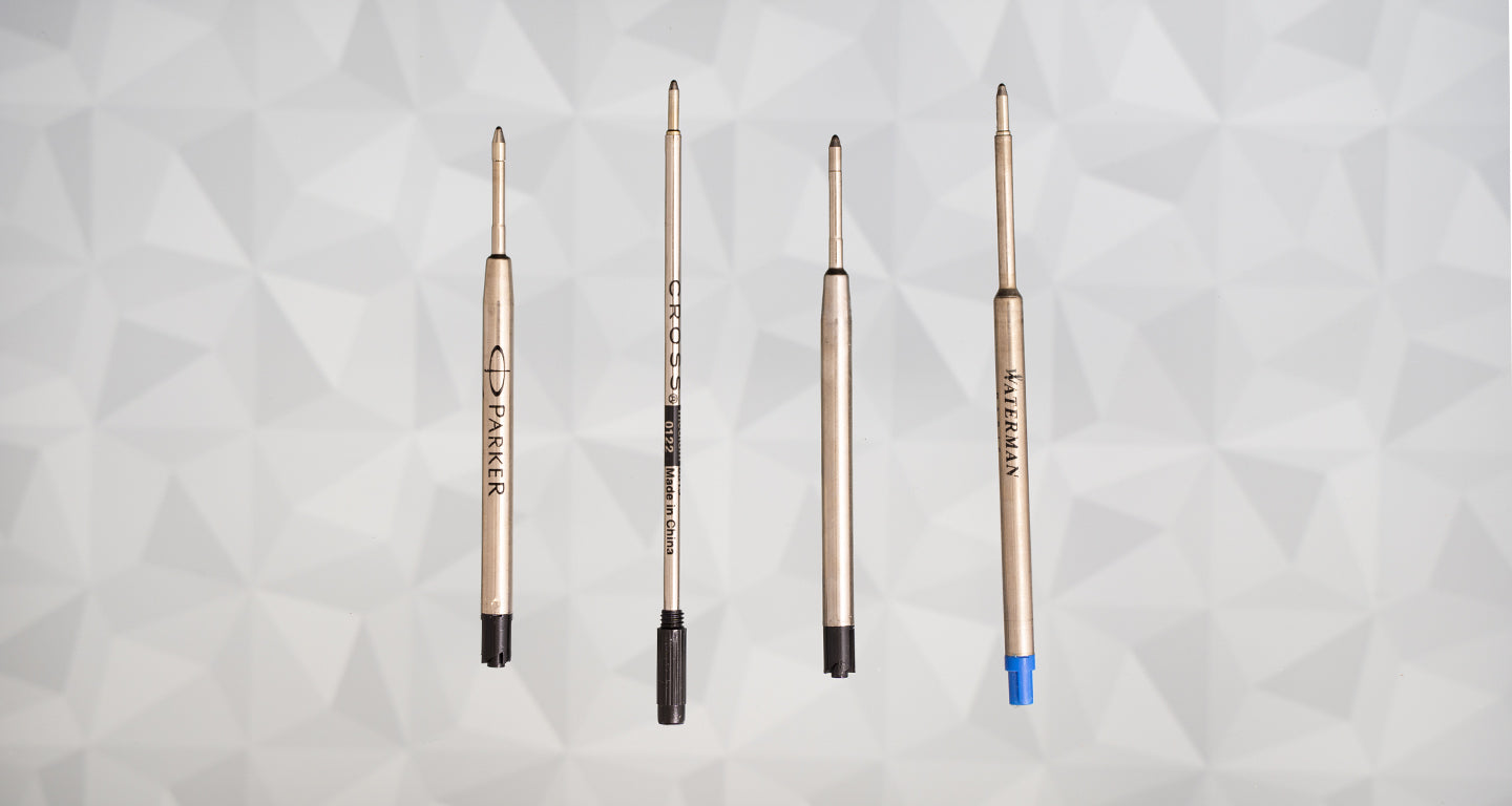 Four different pen refills on a geometric pattern background